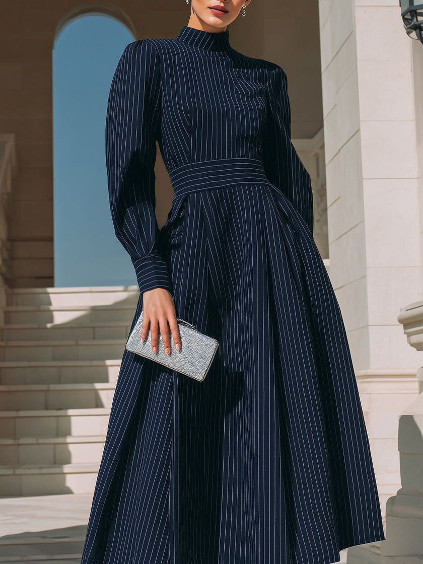 FJØRNA high-neck pinstripe midi dress for women with structured waist and classic style, shown in a full-length view.