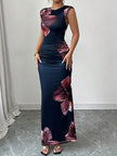 FJØRNA sleeveless white maxi dress with contrast color flower print, round neckline, bodycon fit, perfect for summer occasions.