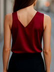 FJØRNA Burgundy satin sleeveless blouse for women with asymmetric neckline, stylish and elegant top for evening or casual wear.