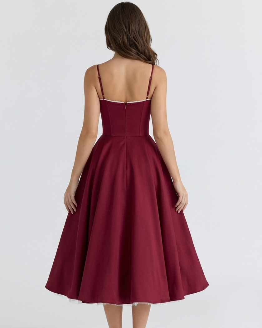 FJØRNA women's corset midi dress with a tulle skirt, featuring a fitted bodice and flowing layered tulle for elegant style.