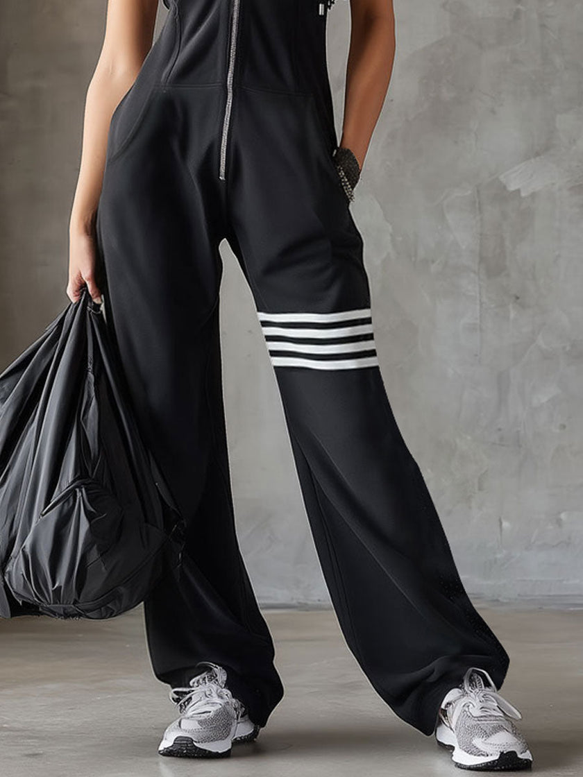 FJØRNA black sleeveless hooded jumpsuit with white vertical stripes, made from lightweight fabric, front pockets, casual style.