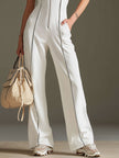 White cotton blend short sleeve wide-leg jumpsuit by FJØRNA, showing the relaxed fit and stylish design.