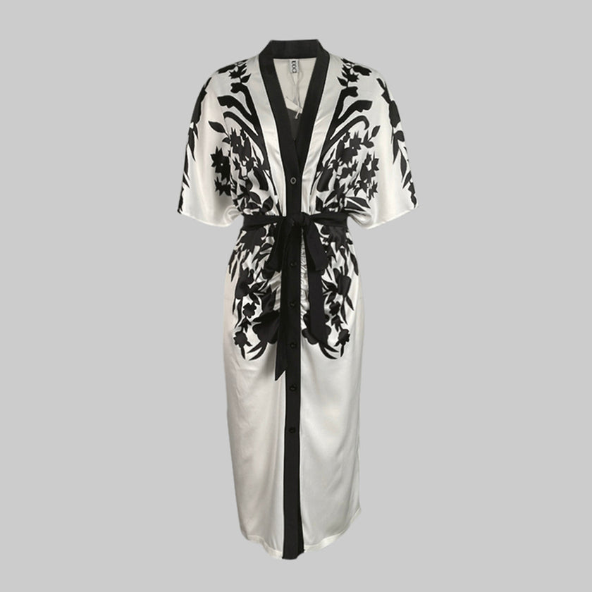 White FJØRNA midi dress with half sleeves, floral print, V-neck, and tied waist for a stylish, feminine look.