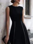 FJØRNA sleeveless A-line midi dress with chain-trim seams, showcasing a flowing silhouette and stylish design.