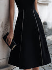 FJØRNA sleeveless A-line midi dress with chain-trim seams, stylish and elegant, displayed on a neutral background.