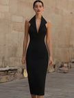 FJØRNA black halter-collar bodycon midi dress for women, sleek and fitted, shown on a model with a stylish background.