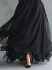 FJØRNA elegant black tulle maxi dress with patchwork details, flowing design, fitted knit style, perfect for formal occasions.