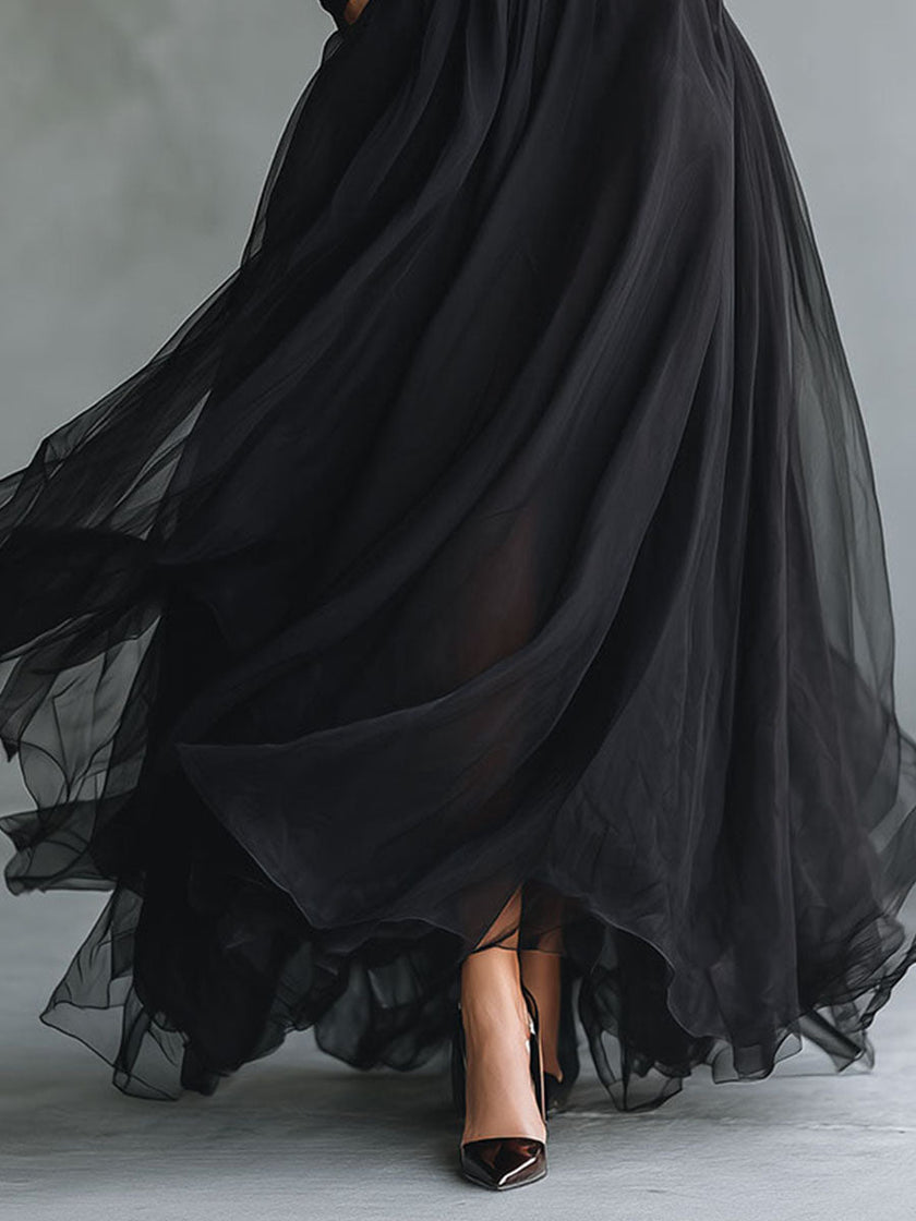 FJØRNA elegant black tulle maxi dress with patchwork details, flowing design, fitted knit style, perfect for formal occasions.