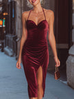 Wine-red velvet halter midi dress by FJØRNA featuring a fitted silhouette, elegant neckline, and smooth burgundy velvet fabric.
