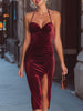 Wine-red velvet halter midi dress by FJØRNA featuring a fitted silhouette, elegant neckline, and smooth burgundy velvet fabric.