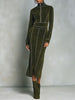 Olive green high neck zip-up midi dress by FJØRNA featuring contrast stitching and long sleeves, displayed on a hanger.