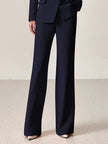 Navy lapel double-breasted two-piece suit set by FJØRNA, featuring a tailored blazer and matching trousers on a hanger.
