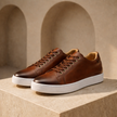 FJØRNA men's breathable leather trainers shoes showing sleek black design and comfortable sneaker style.