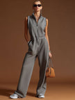 Dark grey FJØRNA cotton blend sleeveless zip-up jumpsuit displayed on a hanger, highlighting its sleeveless design and casual style.