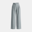 Women’s high waisted pleated wide leg trousers by FJØRNA, showcasing the stylish, flowy fabric and wide-leg design.