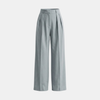 Women’s high waisted pleated wide leg trousers by FJØRNA, showcasing the stylish, flowy fabric and wide-leg design.