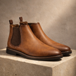 FJØRNA men's Leather Chelsea boots showing sleek black leather with elastic side panels and classic ankle height.