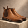 FJØRNA men's Leather Chelsea boots showing sleek black leather with elastic side panels and classic ankle height.