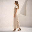 Women’s linen blend suit set by FJØRNA featuring a stylish wide-leg design and tailored fit, shown in a neutral color.
