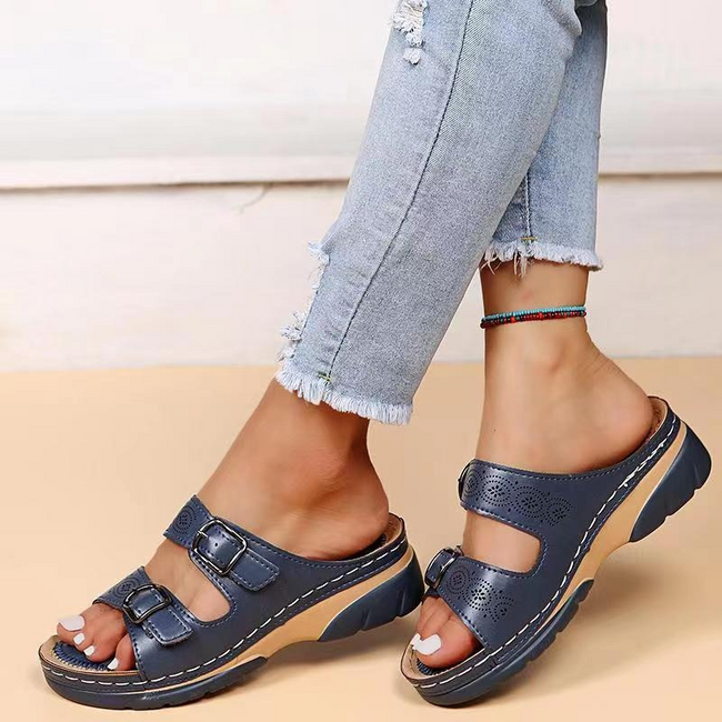 FJØRNA orthopedic comfort fit slide sandals with perforated open toe design, showcasing cushioned footbed and open-toe style.