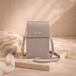 FJØRNA women's crossbody bag in black leather with adjustable strap and minimalist design, suitable for everyday use.