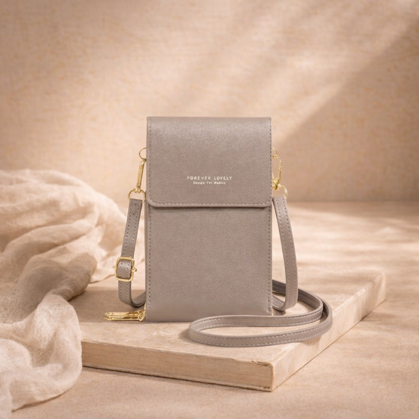 FJØRNA women's crossbody bag in black leather with adjustable strap and minimalist design, suitable for everyday use.