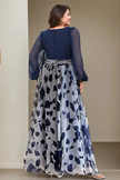 FJØRNA floral print V-neck balloon sleeve maxi wedding guest dress with elegant silhouette and vibrant floral pattern.