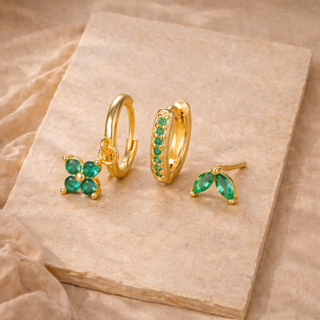 Unisex piercing set from FJØRNA featuring various jewelry accessories for women in silver and gold tones.