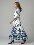 FJØRNA women's floral summer maxi dress with V-neck wrap design, flowing fabric and vibrant floral pattern.