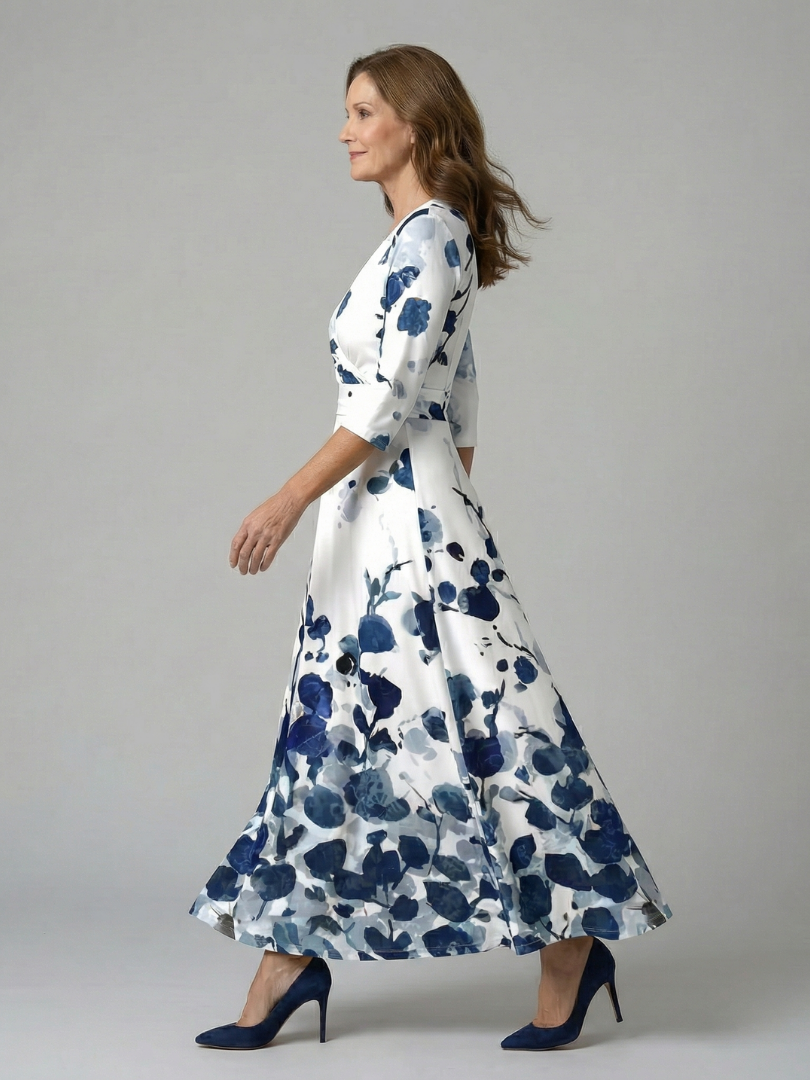 FJØRNA women's floral summer maxi dress with V-neck wrap design, flowing fabric and vibrant floral pattern.