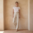 FJØRNA women's linen wide-leg trousers with high waist, tailored fit, and relaxed silhouette, displayed on a model.
