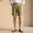 Men's linen shorts by FJØRNA, high waist pleated design, lightweight breathable fabric, shown in natural beige color.