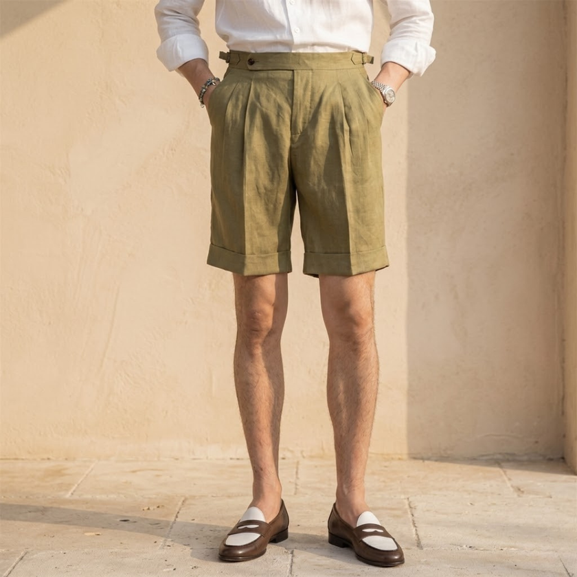 Men's linen shorts by FJØRNA, high waist pleated design, lightweight breathable fabric, shown in natural beige color.