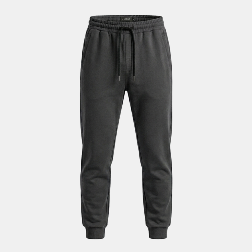 FJØRNA men's relaxed fit joggers with drawstring waist, shown in dark fabric, casual pants for comfortable everyday wear.