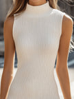 FJØRNA white ribbed knit sleeveless turtleneck dress for women, showcasing a sleek, fitted design with a high neckline and sleeveless style.