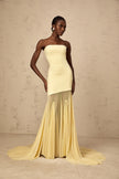 FJØRNA Josiane yellow off-shoulder sheer tulle maxi dress displayed on a model, featuring flowing fabric and elegant design