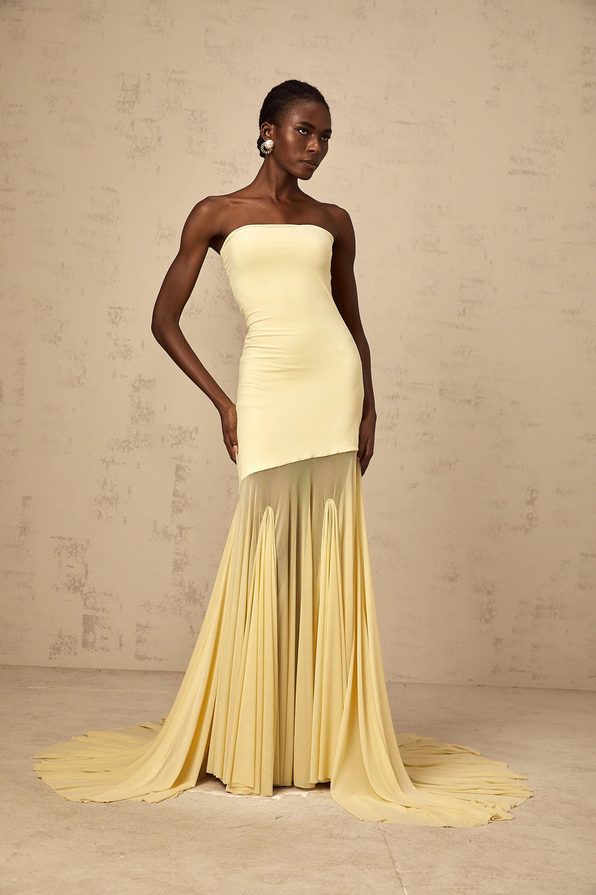 FJØRNA Josiane yellow off-shoulder sheer tulle maxi dress displayed on a model, featuring flowing fabric and elegant design