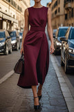 FJØRNA solid color sleeveless round neck casual midi dress hanging on a clothing rack, showcasing its simple, elegant design.