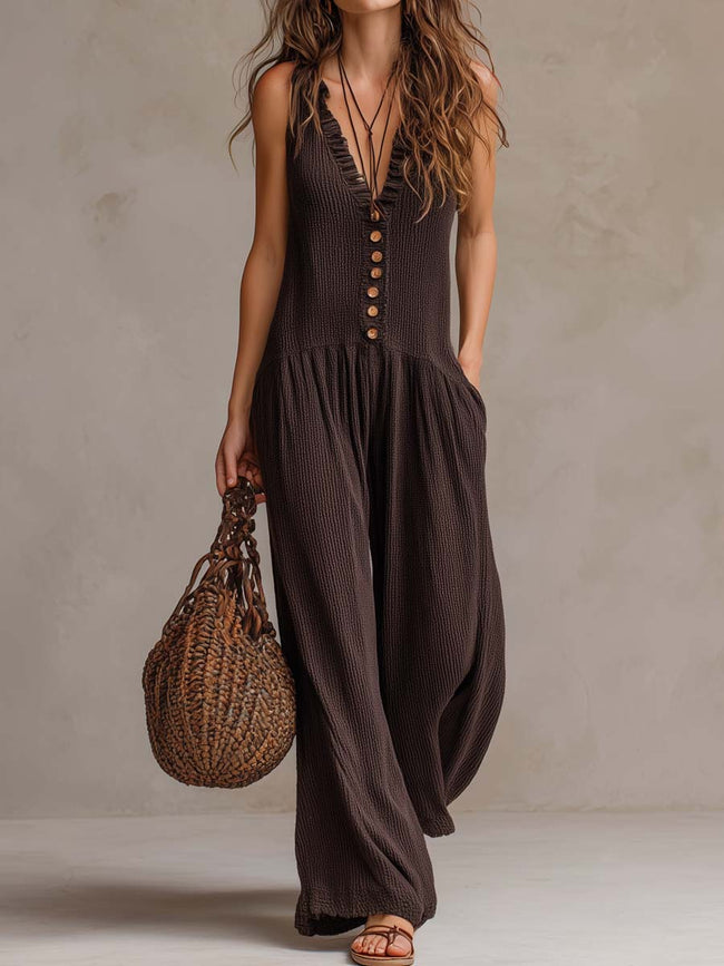 FJØRNA brown sleeveless knitted jumpsuit with ruffle neck and retro style, showcasing a fitted, stylish design.
