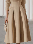 Beige blazer-style midi dress by FJØRNA, featuring a tailored blazer design with a midi length and sleek, sophisticated style.
