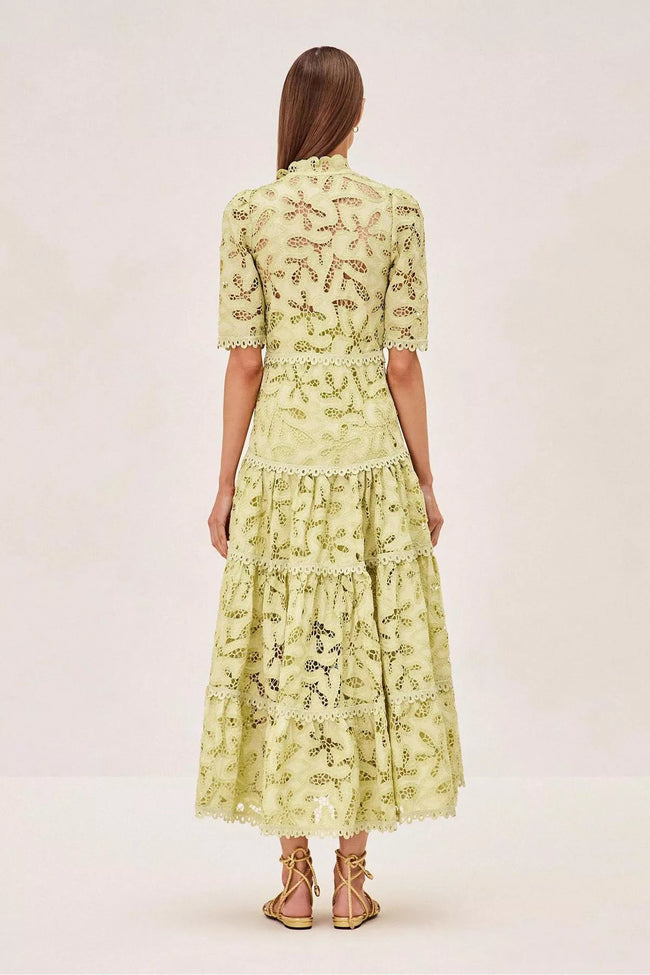 FJØRNA Ledina Midi Green Dress, elegant sleeveless dress with a flowy silhouette and V-neckline, on a model.
