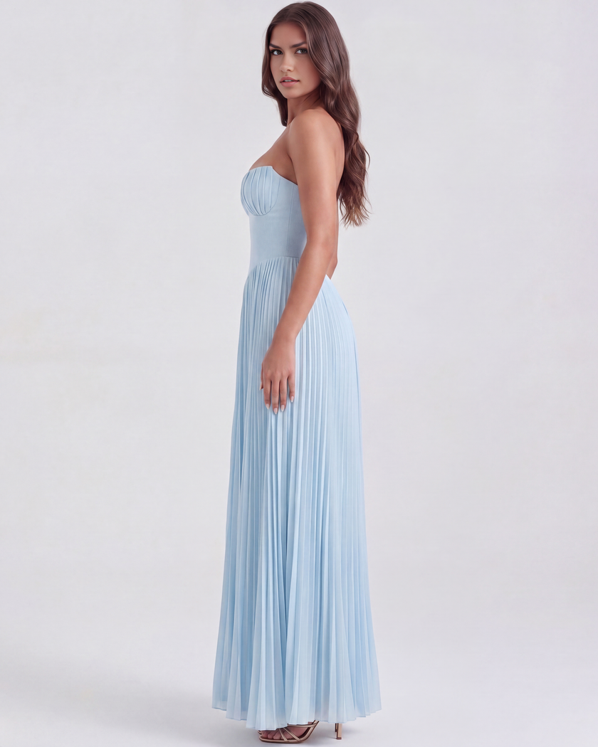 Women's strapless pleated maxi dress with corset bodice by FJØRNA, shown in a topaz color.
