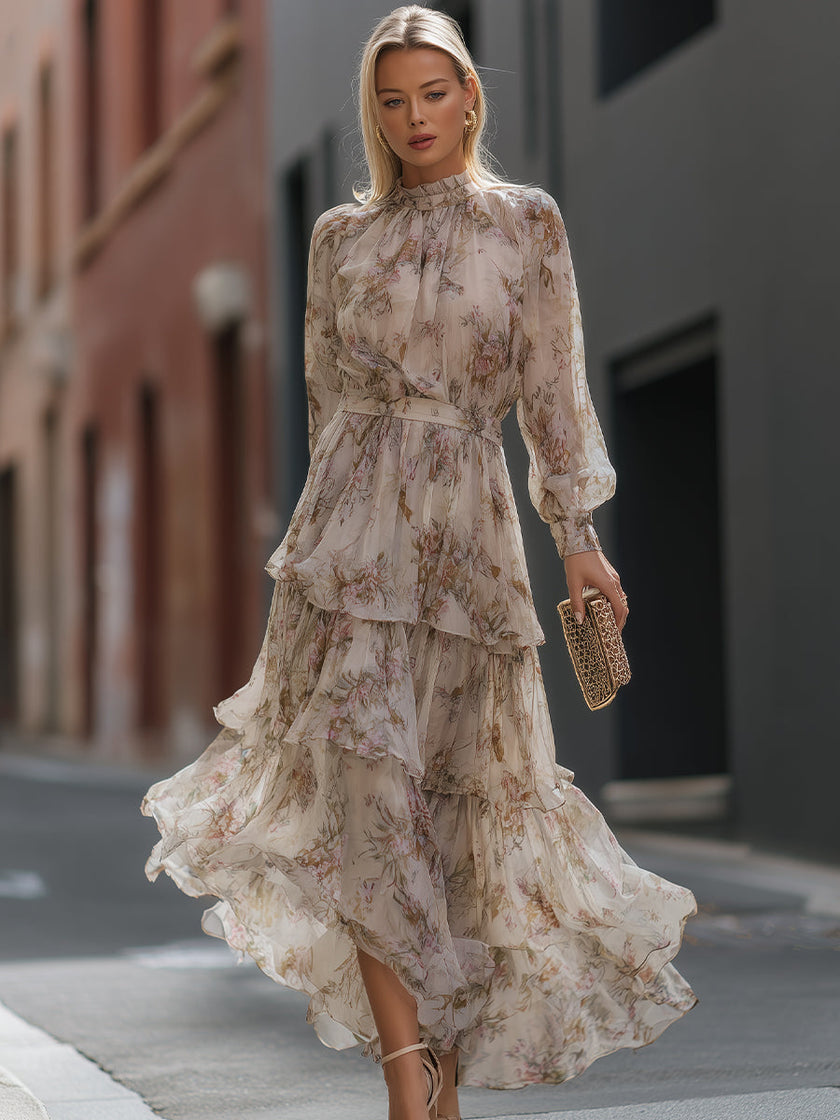 FJØRNA high neck tiered floral maxi dress with long sleeves and ruffled layers, featuring a vibrant floral pattern.