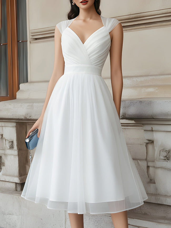FJØRNA V-neck pleated midi dress with cap sleeves, flowing fabric, and elegant design, suitable for formal and casual occasions.