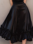 FJØRNA satin ruffled midi dress with spaghetti straps, featuring a flowy design and elegant satin fabric.