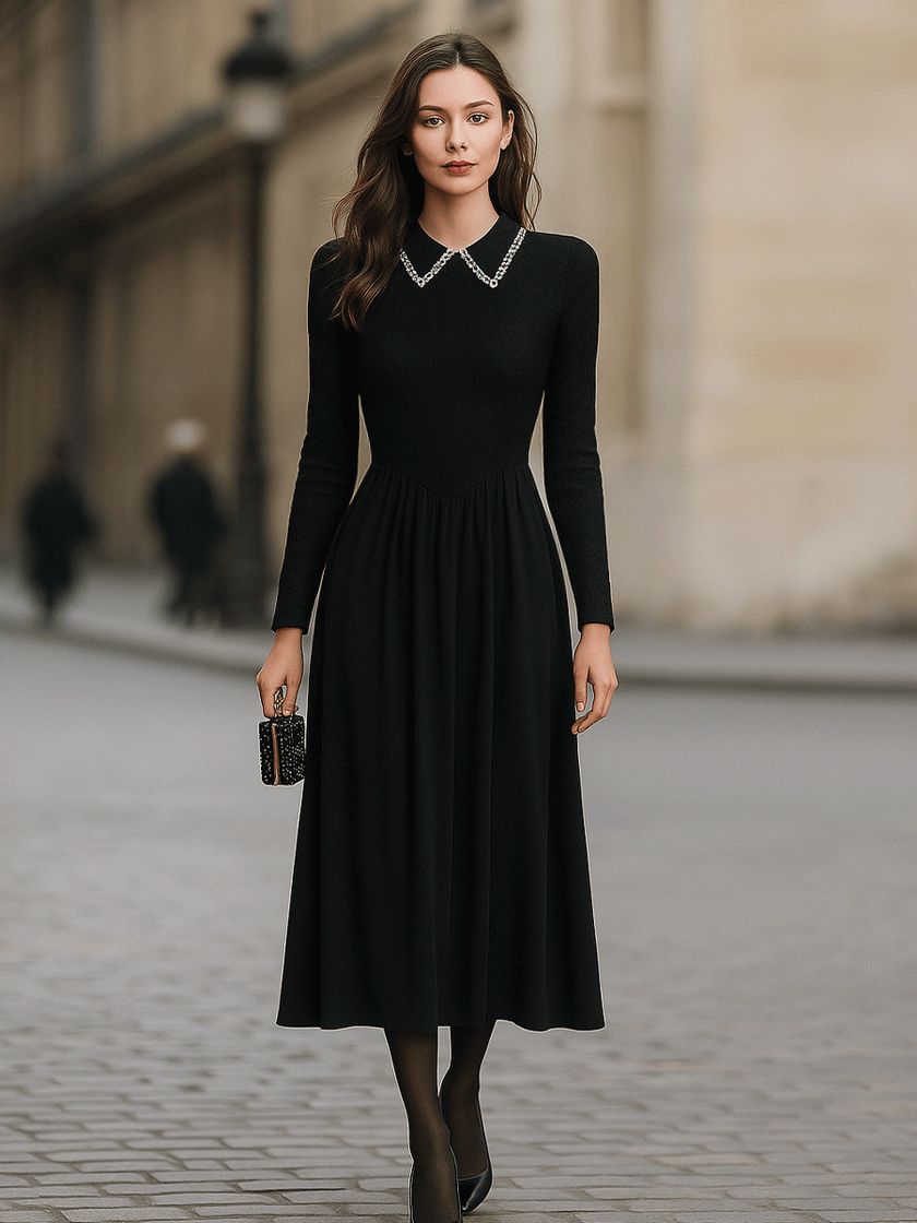 Black long-sleeve midi dress by FJØRNA with an embellished collar, stylish and elegant for formal or evening wear.