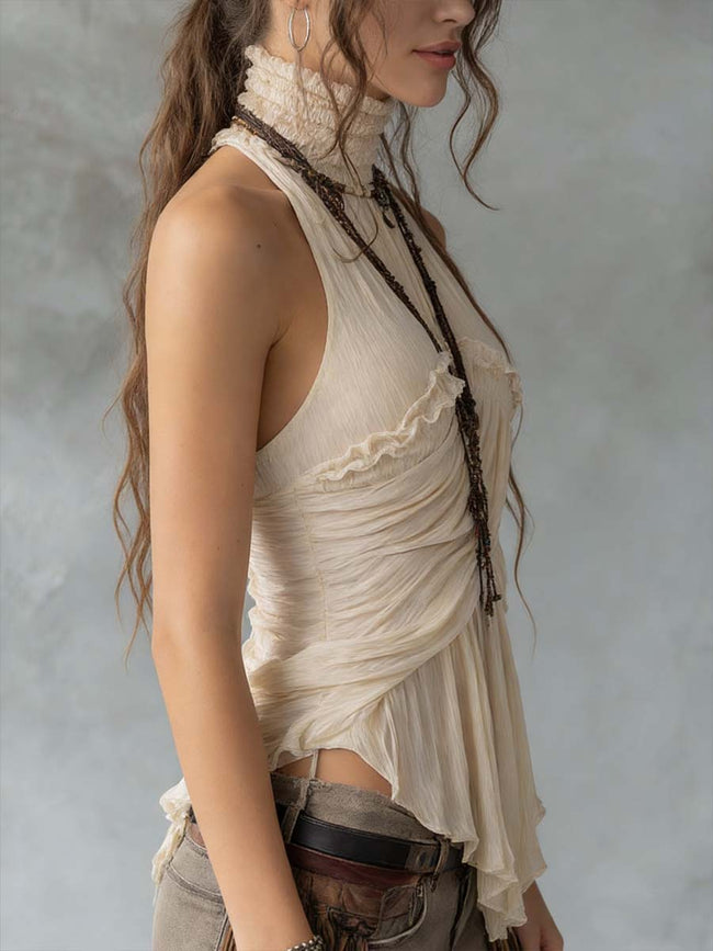 Ivory pleated halter neck chiffon sleeveless blouse for women by FJØRNA, featuring elegant pleats and a flowy fabric.