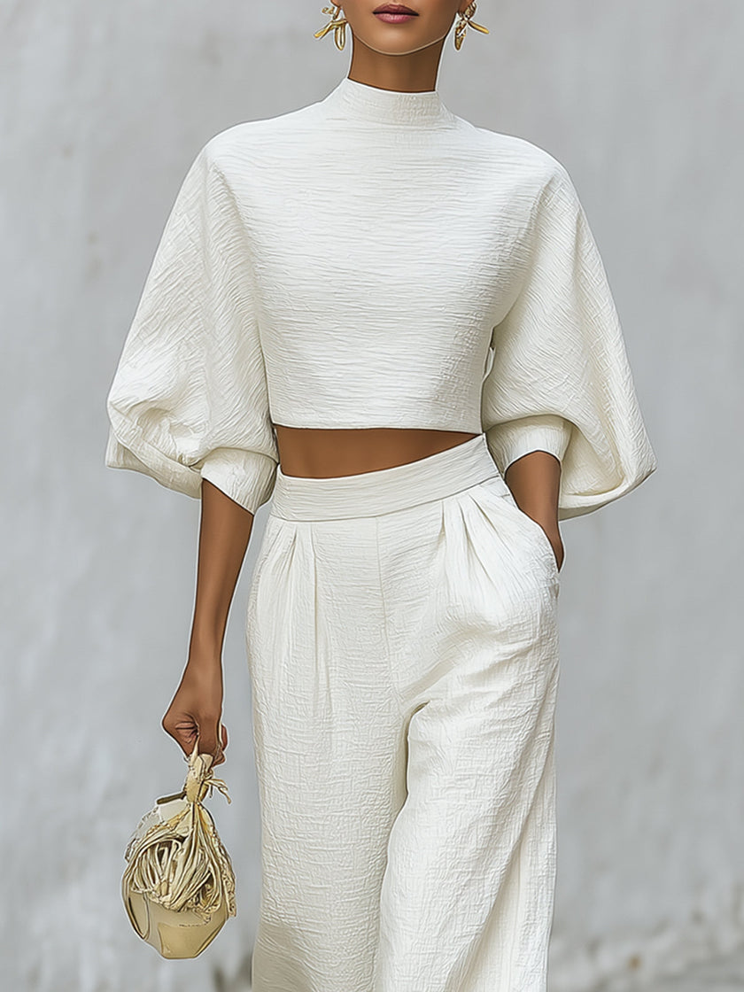 Cream textured lantern sleeve two-piece pants set by FJØRNA featuring a stylish top and matching trousers.