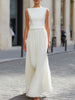 FJØRNA sleeveless boat neck pleated maxi dress with flowing fabric and elegant design, perfect for summer or formal occasions.