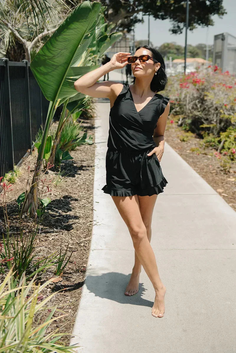 FJØRNA women's summer tankini set with ruffles and V-neck, featuring a colorful swim top and matching bottoms for beachwear.